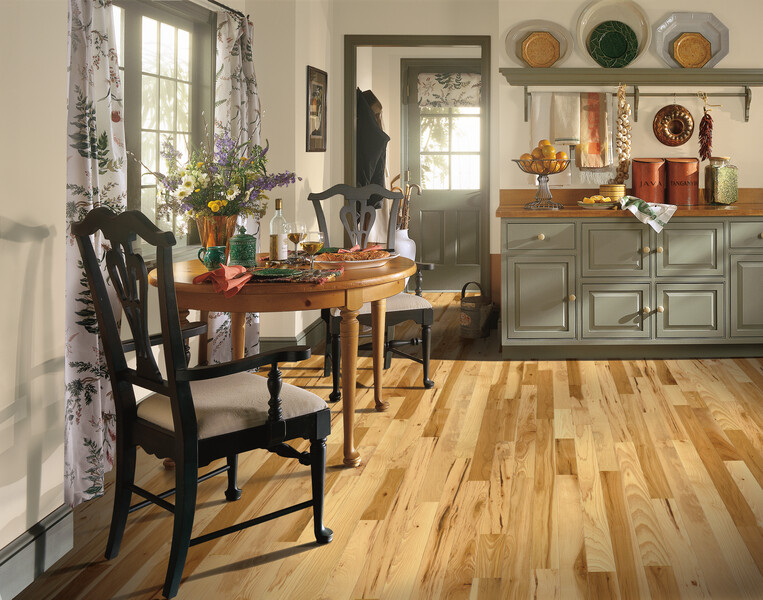 Kitchen area with chairs and side table featuring hickory hardwood flooring