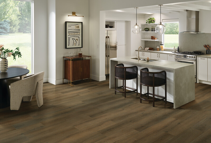 Small kitchen with a seated island showing wood-look vinyl